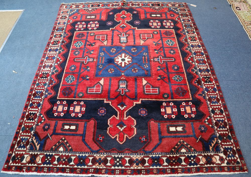 A Caucasian design red ground geometric rug, 204 x 160cm